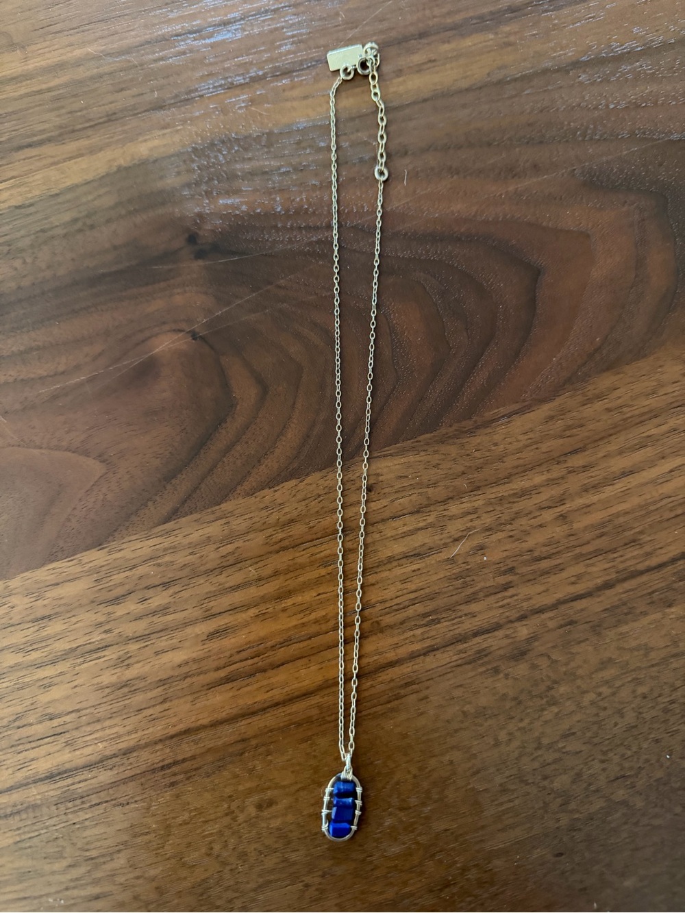 Judith Bright four stone gold necklace with Lapis stones.